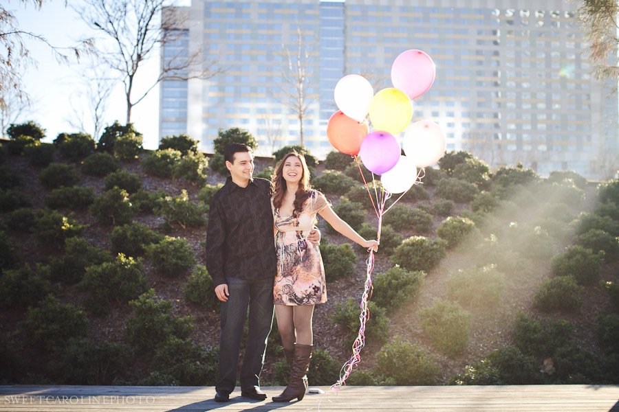 couple holding colorful balloons
