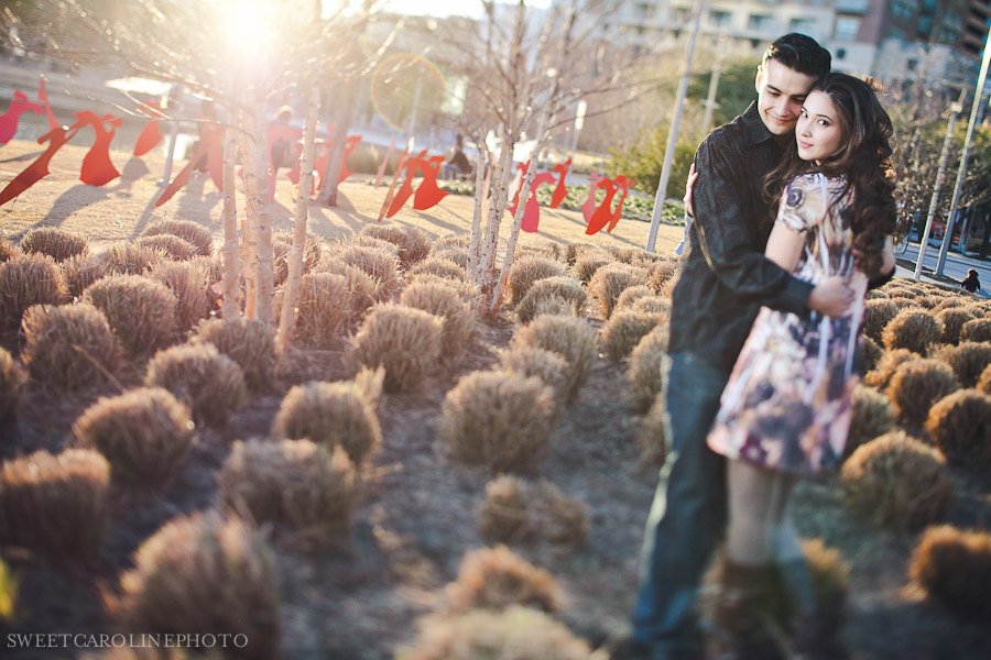 couple holding each other for engagement session shot with tilt shift lens