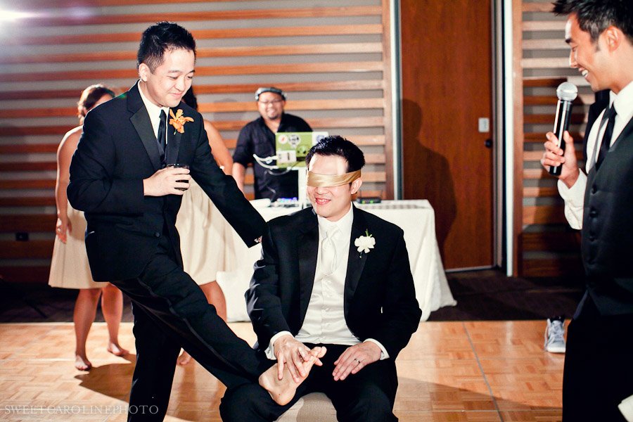 groom rubbing best man's foot at Lakeway Resort and Spa wedding