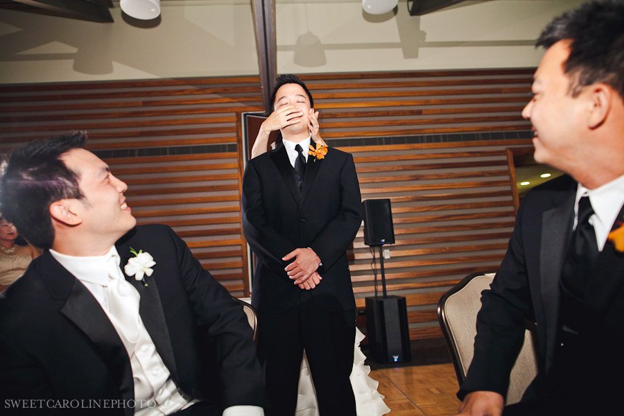 bride touching face of best man for wedding game