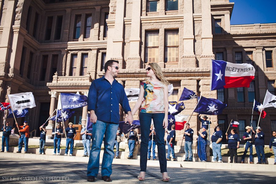 couple in front of protest about independent Texas seceding from the U.S. in front of Austin Capitol