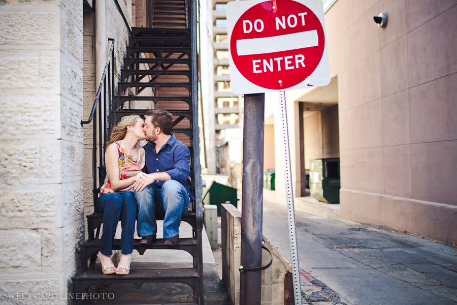couple kissing on steps behind do not enter sign
