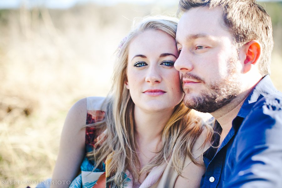 couple with blue eyes looking at camera in field