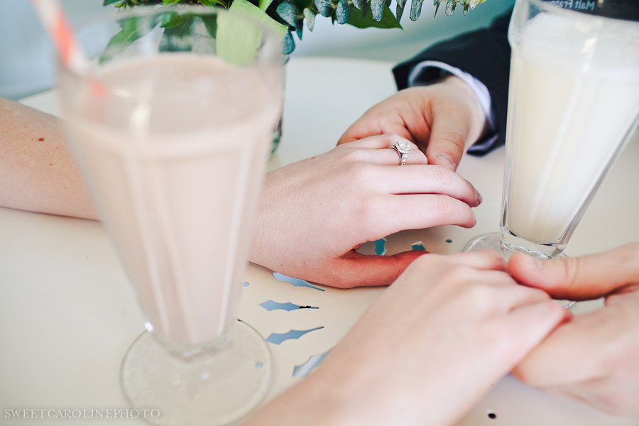 engaged couple holding hands with milk