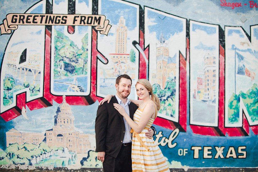 engaged couple in front of the Austin mural for engagement session