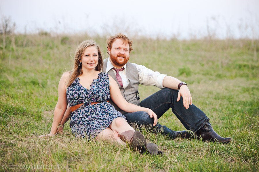 couple smiling looking at camera in field