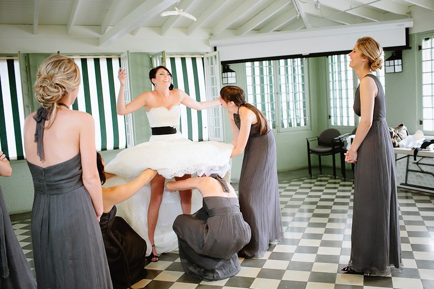 Bride's maids helping the bride get ready for wedding at Laguna Gloria
