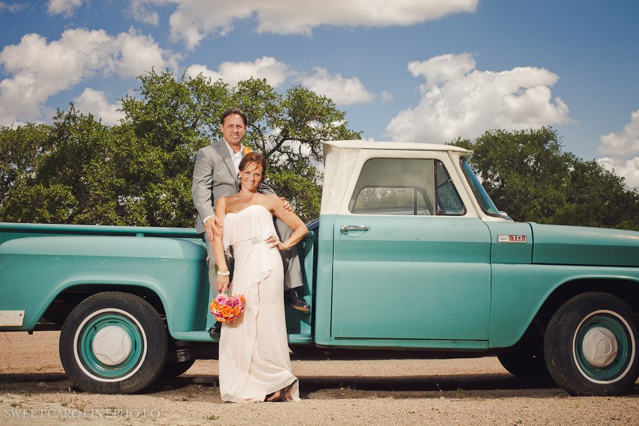 bride and groom in front of vintage truck