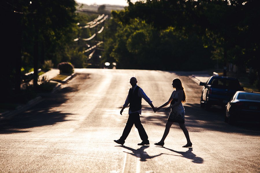 silhouette of couple walking in street