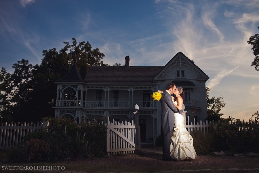 bride and groom kissing at sunset at Barr Mansion