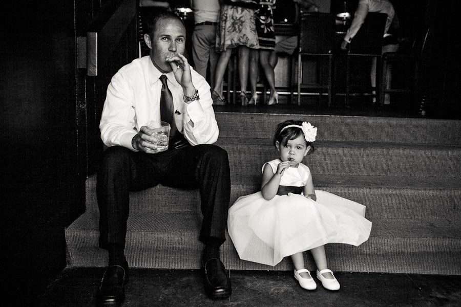 Little flower girl imitating her dad at the wedding reception at horseshoe bay resort