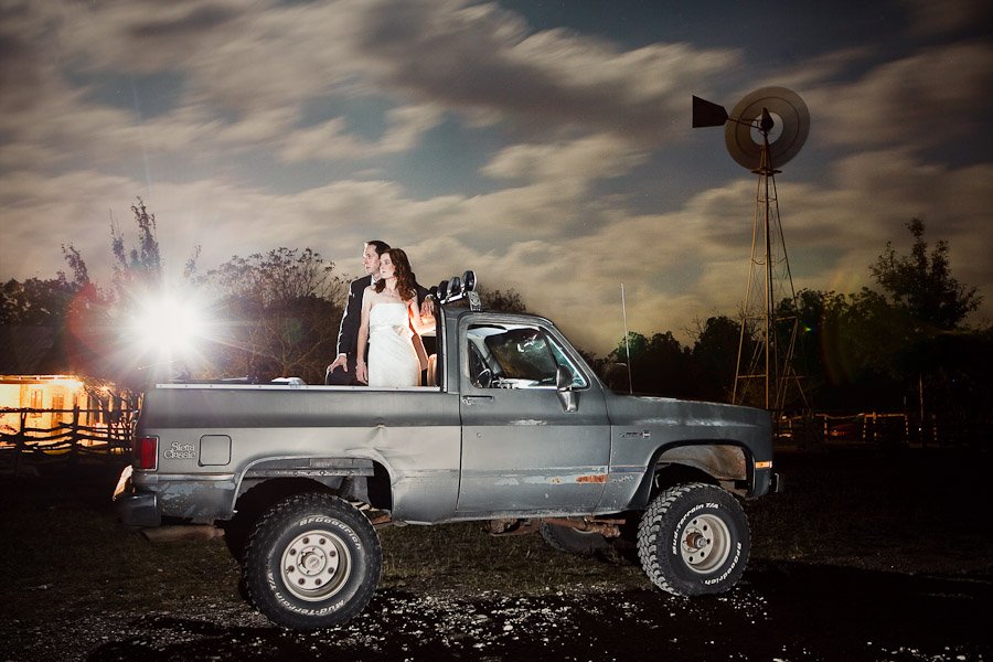 Strobist lite portrait of bride and groom on their Jimmy truck at Salt Lick Pavillion