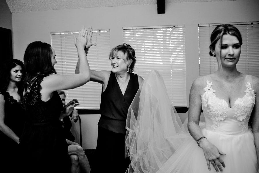 mother of bride high-fiving bridesmaid