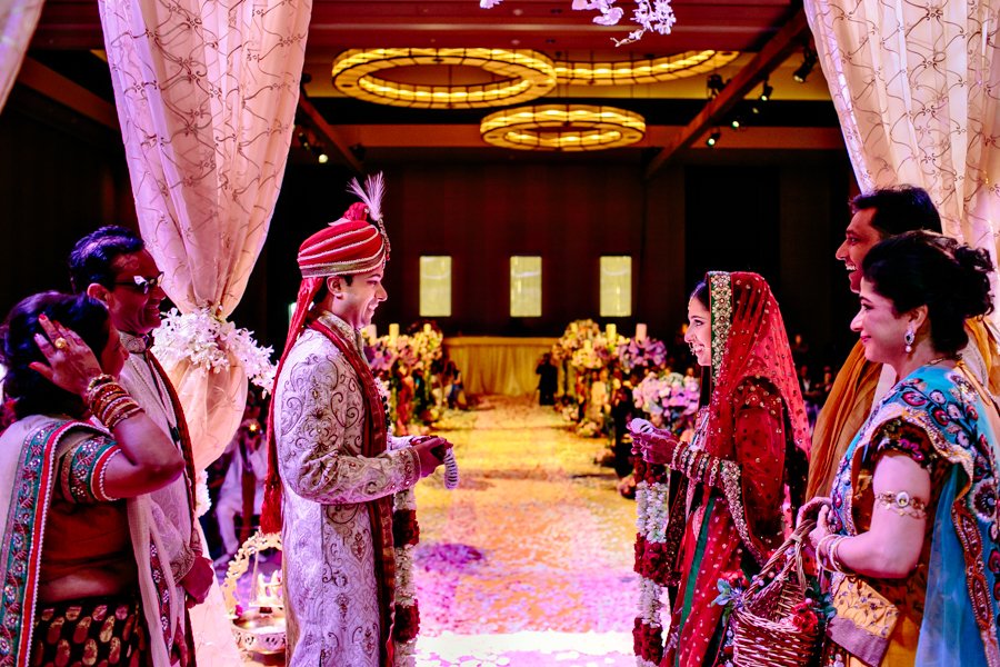 indian bride and groom exchanging garlands