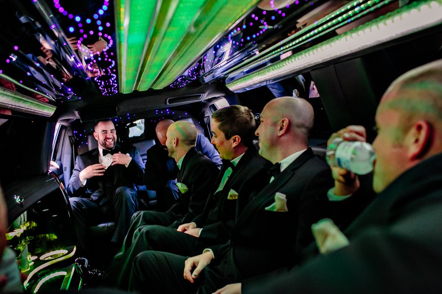 groom and groomsmen in limo