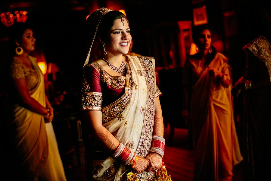 bride in formal red and gold sari