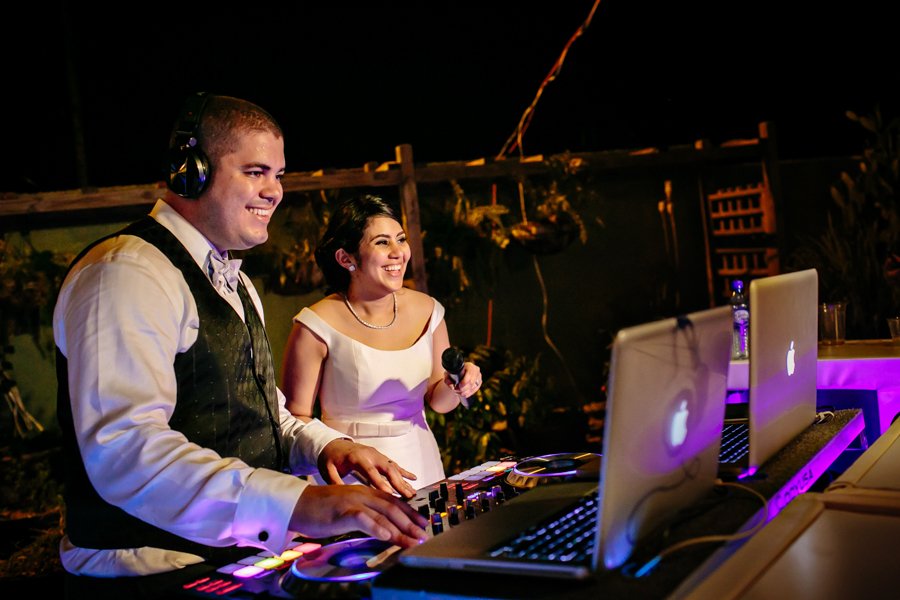 bride and groom playing DJ