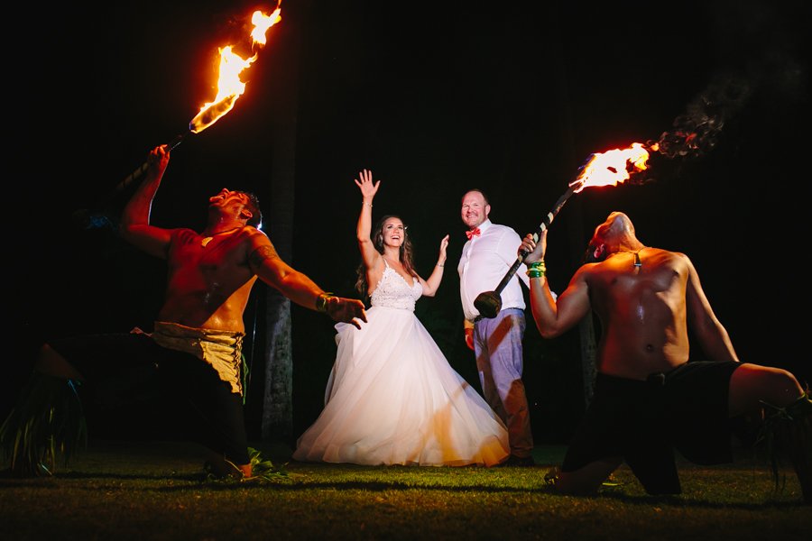 bride and groom with fire dancers