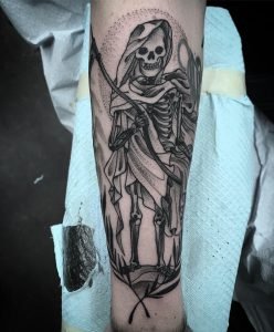 Blackwork tattoos can be striking whether they're patterns or figures like this reaper by Jesse Iris