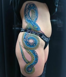 Beautiful tattoos in Long Beach--large blue snake on client's side by Owen Juarez.