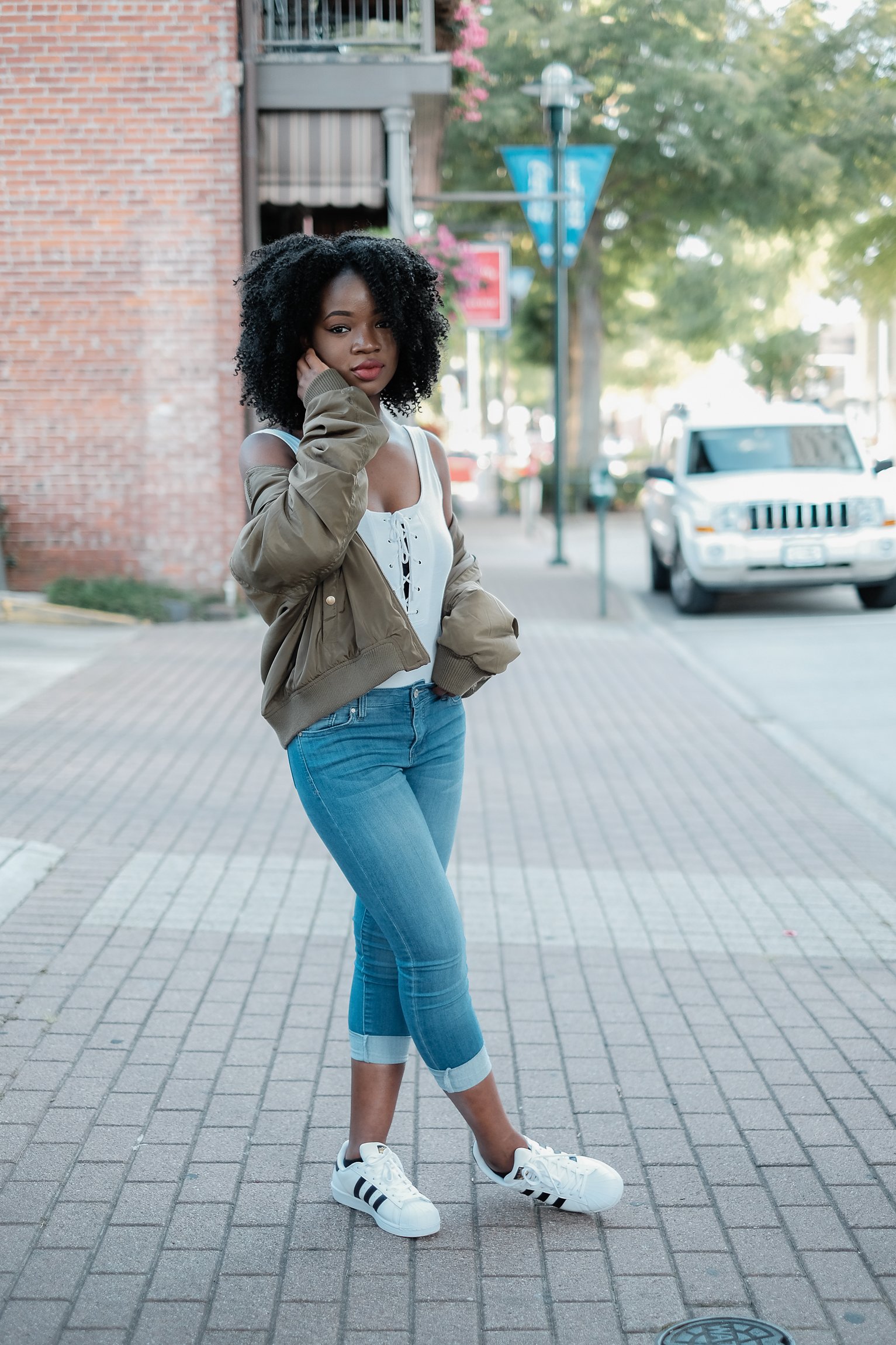 black girl in blue jeans and white top