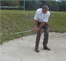 Playing out of firm bunker sand.