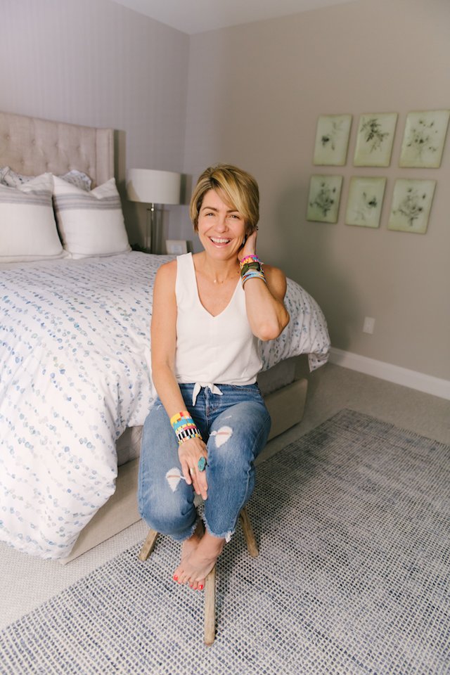 Guest Bedroom Ideas featured by top US life and style blog Seersucker + Saddles; Image of a woman wearing a white tank and jeans.