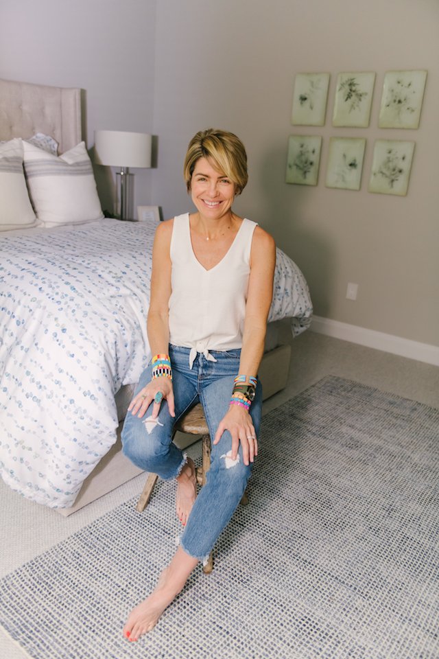 Guest Bedroom Ideas featured by top US life and style blog Seersucker + Saddles; Image of a woman wearing a white tank and jeans.