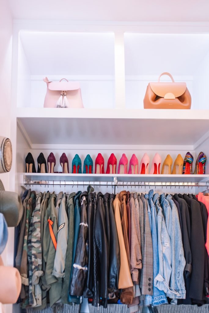 Closet Layout by popular Indianapolis life and style blog, Seersucker and Saddles: image of white shelving containing purses and shoes and jewelry, and clothes hanging on out clothing rod in a walk-in closet. 