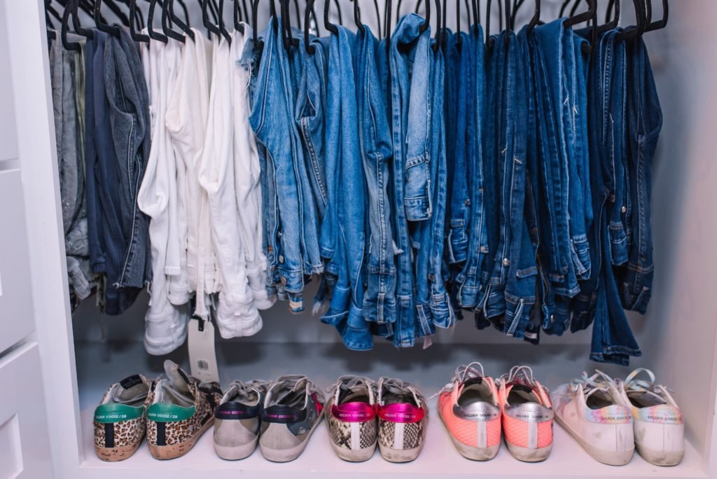 Closet Layout by popular Indianapolis life and style blog, Seersucker and Saddles: image of jeans and sneakers in a walk-in closet. 