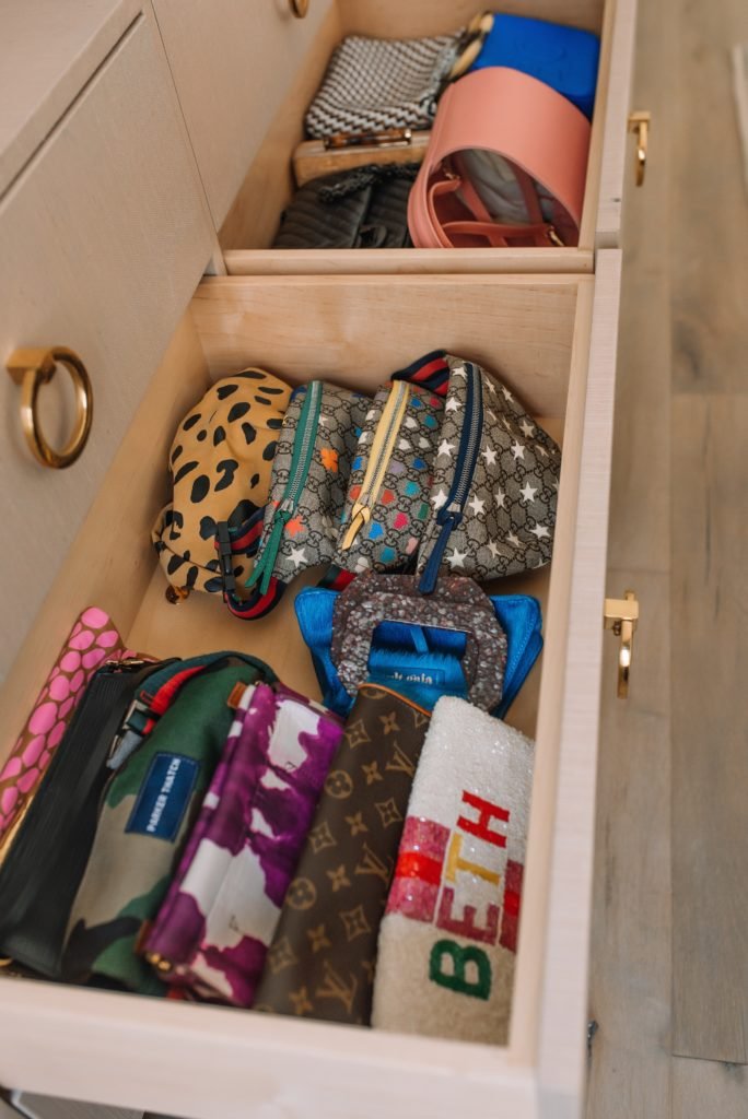Closet Layout by popular Indianapolis life and style blog, Seersucker and Saddles: image of two opened drawers filled with various clutches and belt bags. 