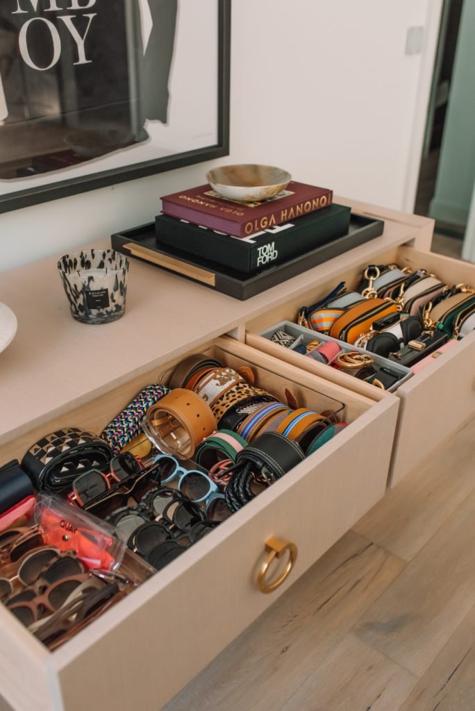Closet Layout by popular Indianapolis life and style blog, Seersucker and Saddles: image of two opened drawers filled with clutches, belts, and sunglasses. 