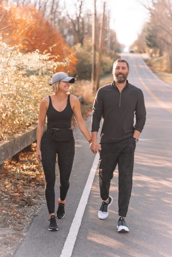 Athletic Apparel by popular Indianapolis fashion blog, Seersucker and Saddles: image of Beth Chappo and her husband walking hand in hand outside and wearing Lululemon athletic apparel. 