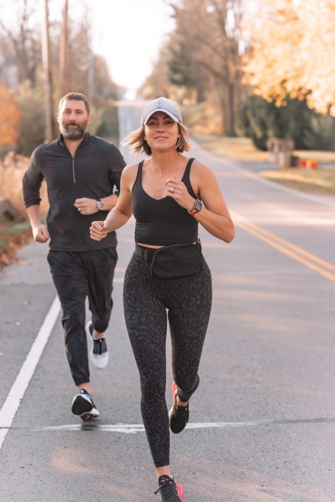 Athletic Apparel by popular Indianapolis fashion blog, Seersucker and Saddles: image of Beth Chappo and her husband running together outside and wearing Lululemon athletic apparel. 