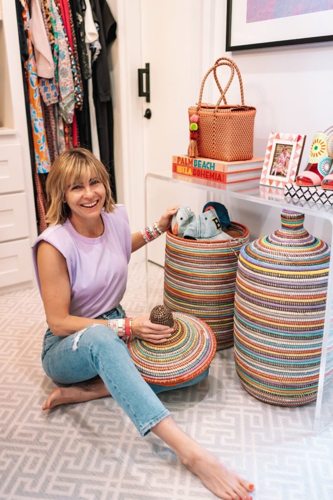 AGOWA Handmade Baskets by popular Indianapolis life and style blog, Seersucker and Saddles: image of a woman sitting on her closet floor next to two AGOWA handmade baskets. 