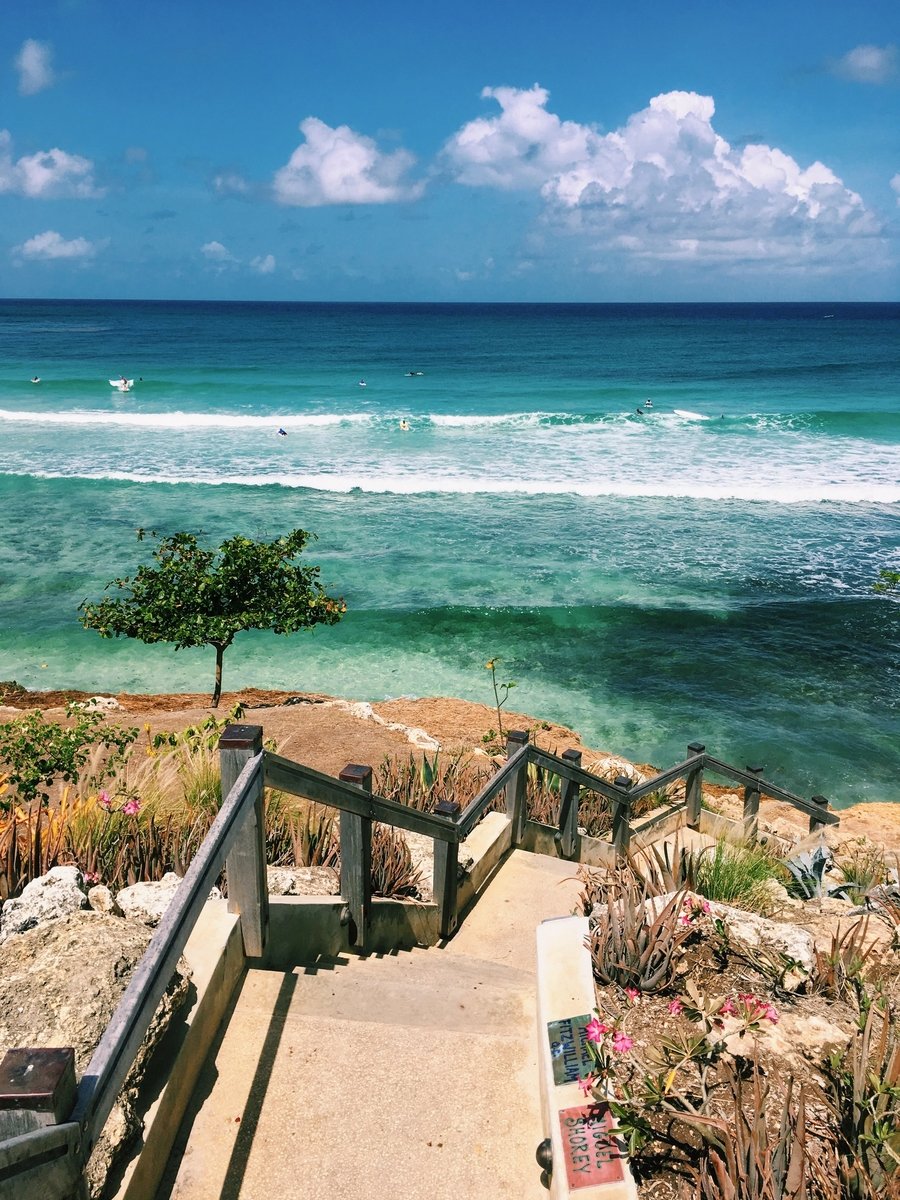 Steps leading down to the bright blue and green ocean in Freights Bay, Barbados.