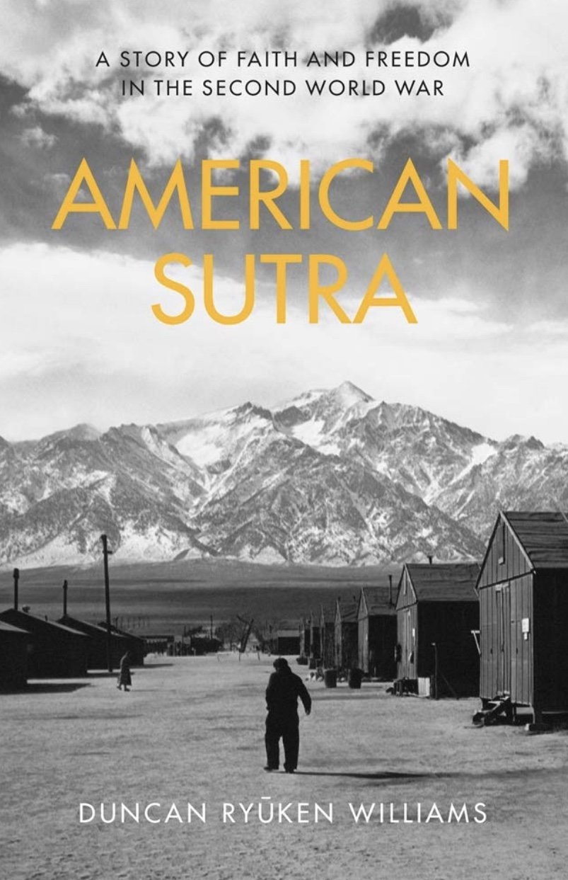 Book cover of “American Sutra” with the title in yellow font against a black and white landscape of mountains, foregrounded by a person walking through a row of wooden buildings.