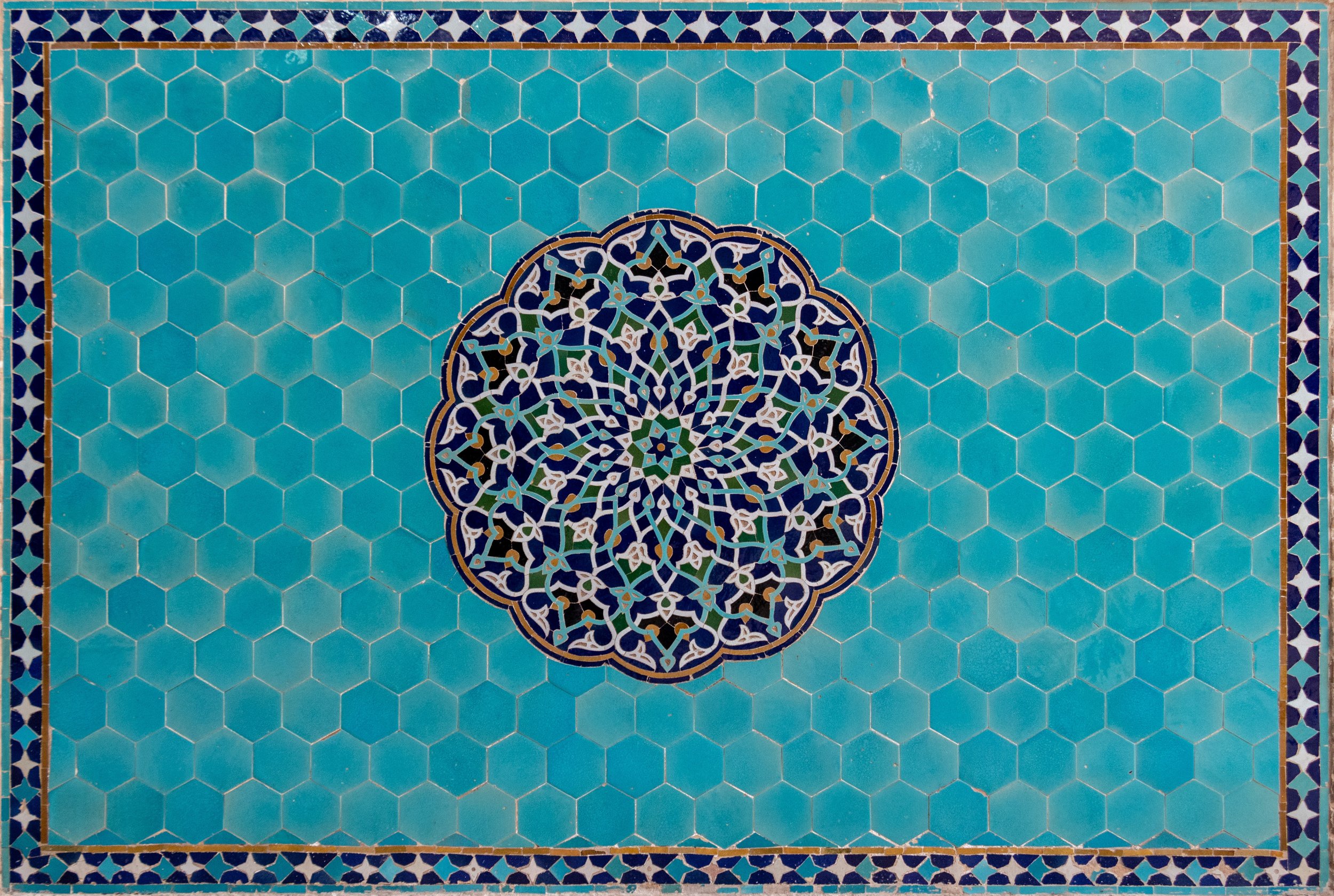 Intricate blue, white, and gold tiles at Jame Mosque, in Yazd province, Iran.
