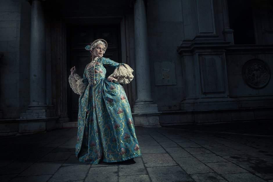 Image of woman in 17th century costume running away from the light