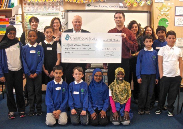 The Childhood Trust trustee David Lewis presents Apollo Music Projects' CEO David Chernaik with a cheque for £4,000.