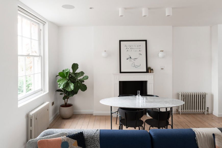 A grey marble table sits inside the living room of this Georgian Hackney home