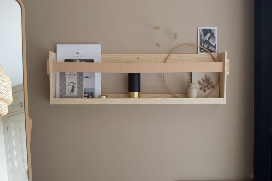 A Scandi inspired Nordic luxe bedroom with a wood and leather shelf by SSM. 