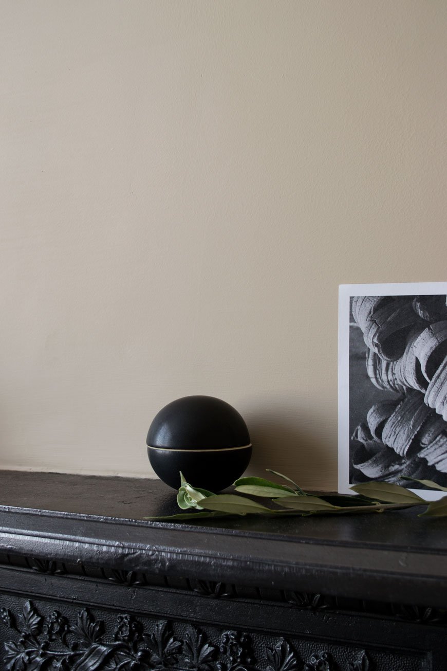 how to style your home for winter with a black round ceramic bonbon pot from NABO shop which sits on a Victorian mantlepiece.