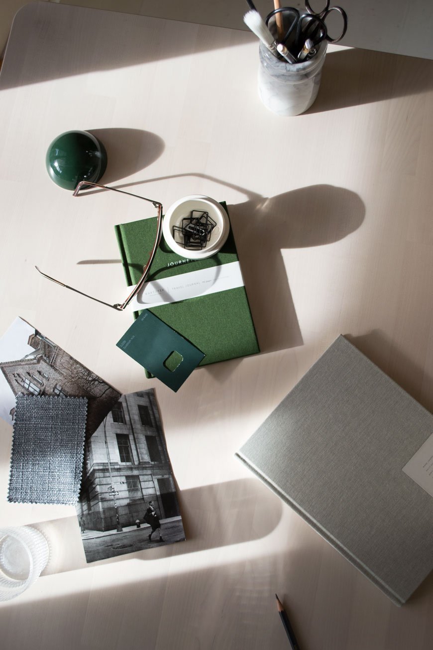 Stark shadows across a desk with green and grey Danish stationery from NABO