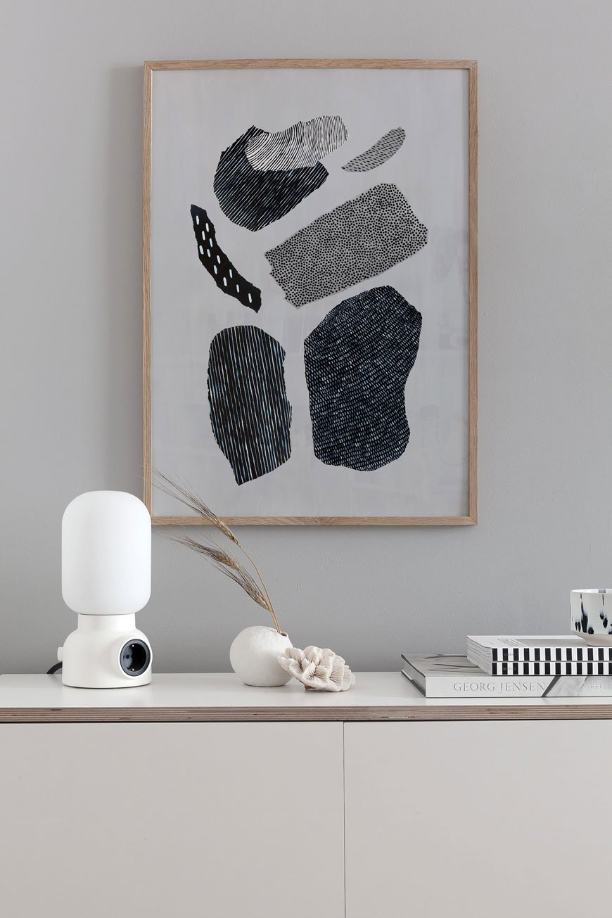 Abstract wall art styled above a plywood sideboard, designed by Coco Lapine Design.