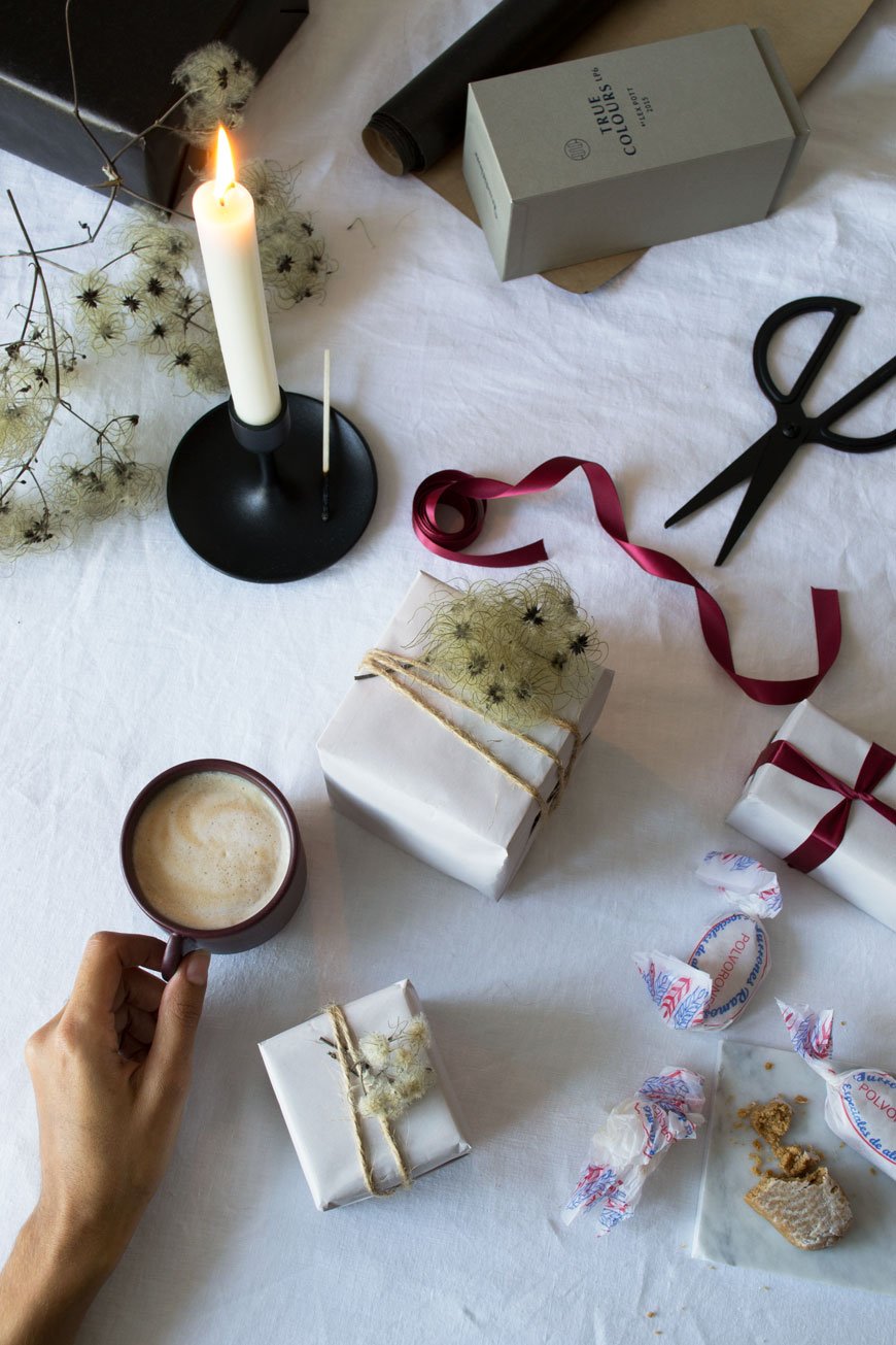 A present wrapping flatlay on my dining table, sharing tips for natural, Nordic Christmas decorations