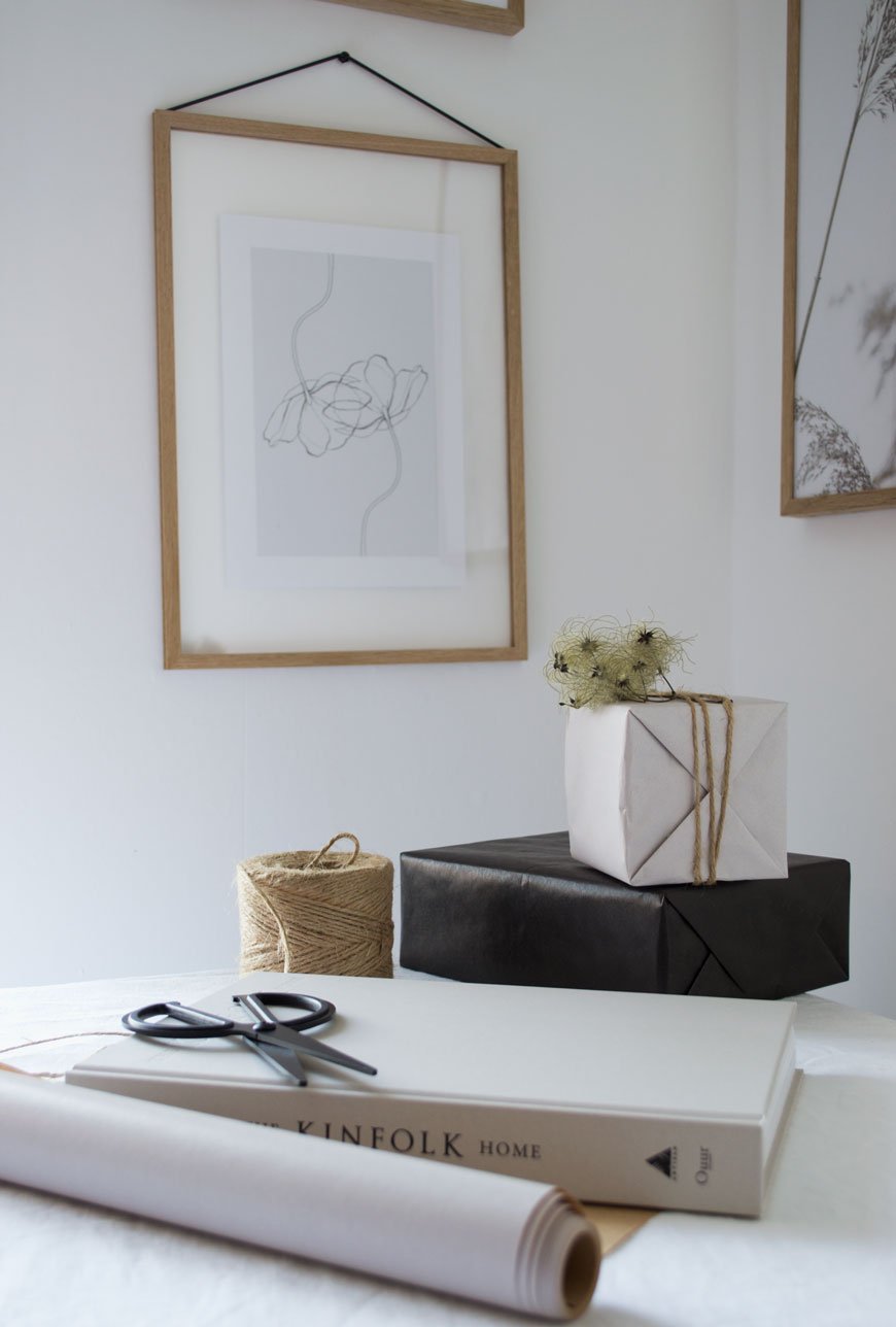 Wrapping gifts on the table with black and white gift wrap, sharing my tips for Nordic Christmas style.