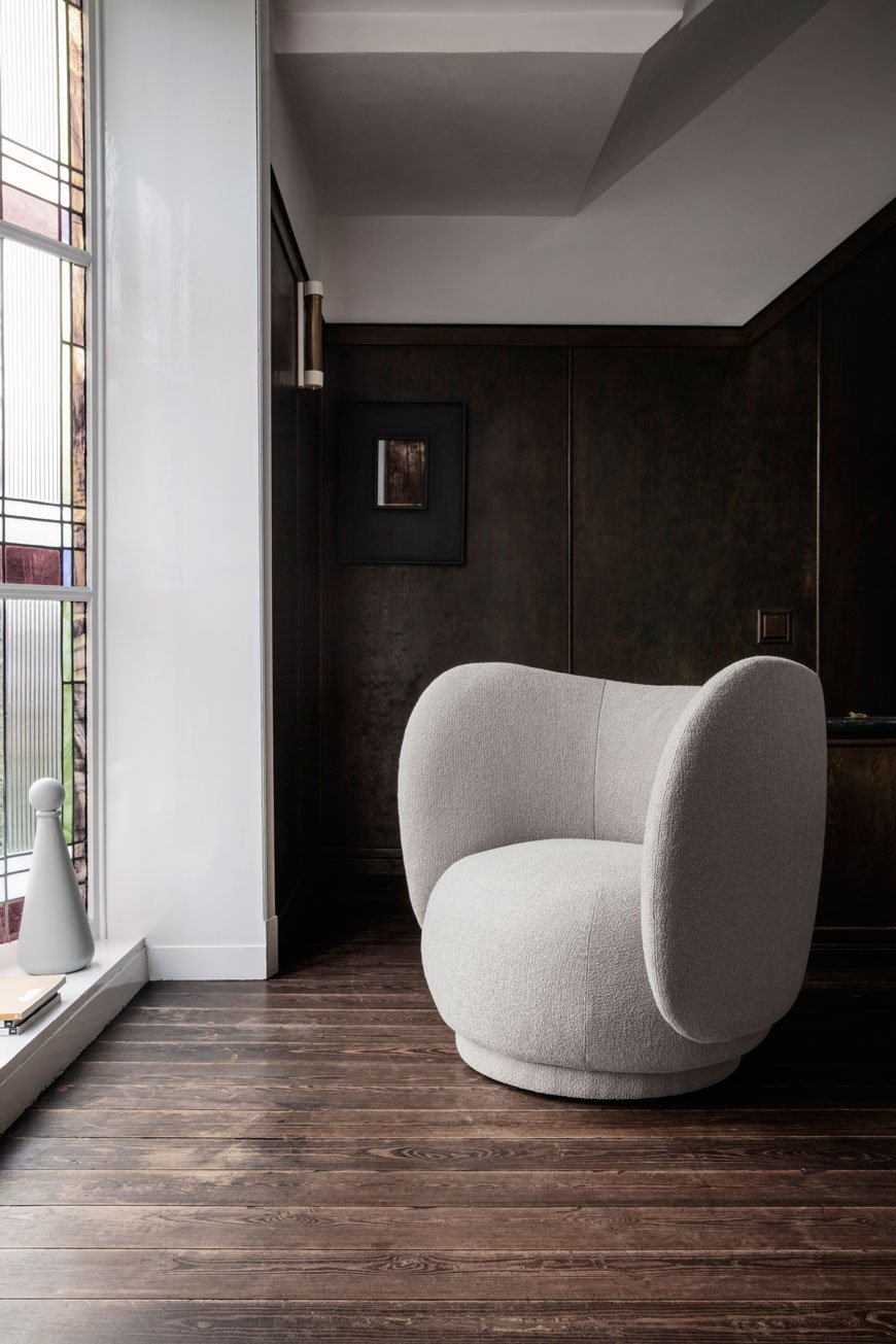 A dark and moody interior sets of the pale and interesting Rico lounge chair, designed by Ferm Living.