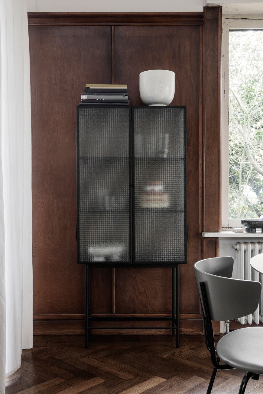 Haze Vitrine with a slim black metal frame and diffused glass front, designed by Ferm Living.