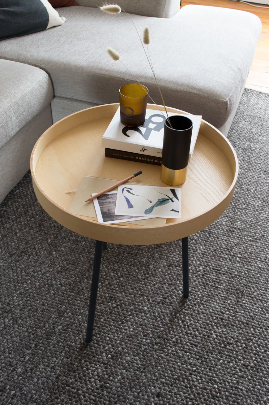 A small tray acts as a coffee table on top of a timeless grey rug from Habitat. 